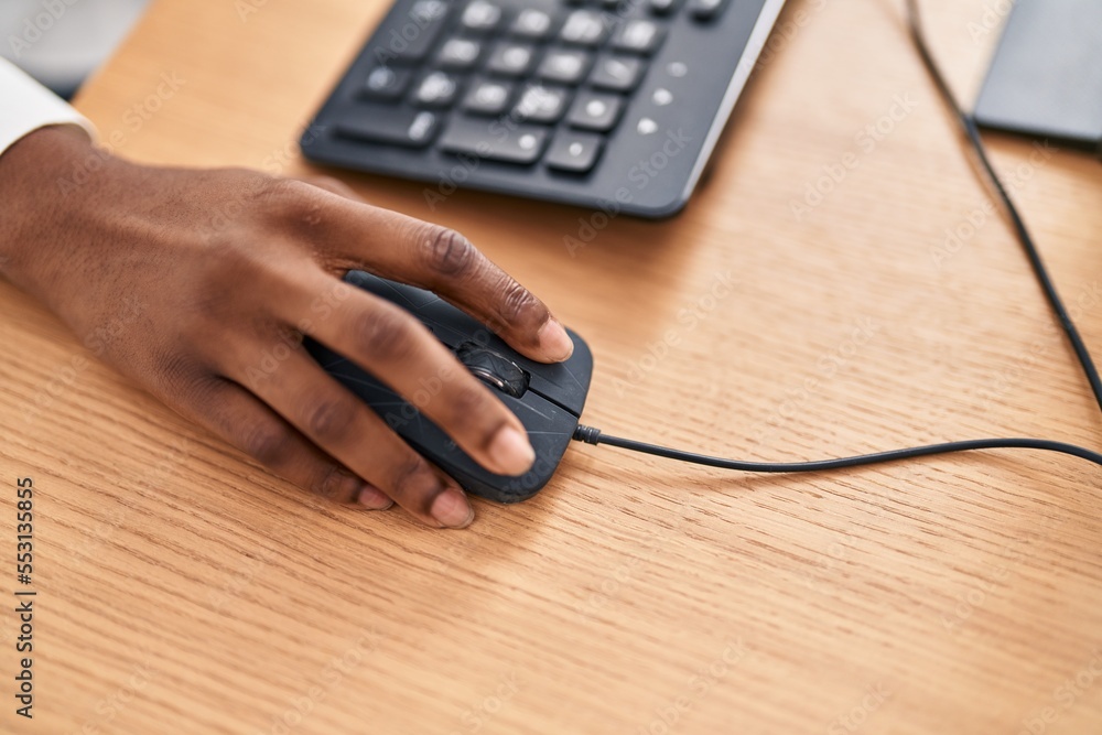 African american woman using computer mouse at office - obrazy, fototapety, plakaty 