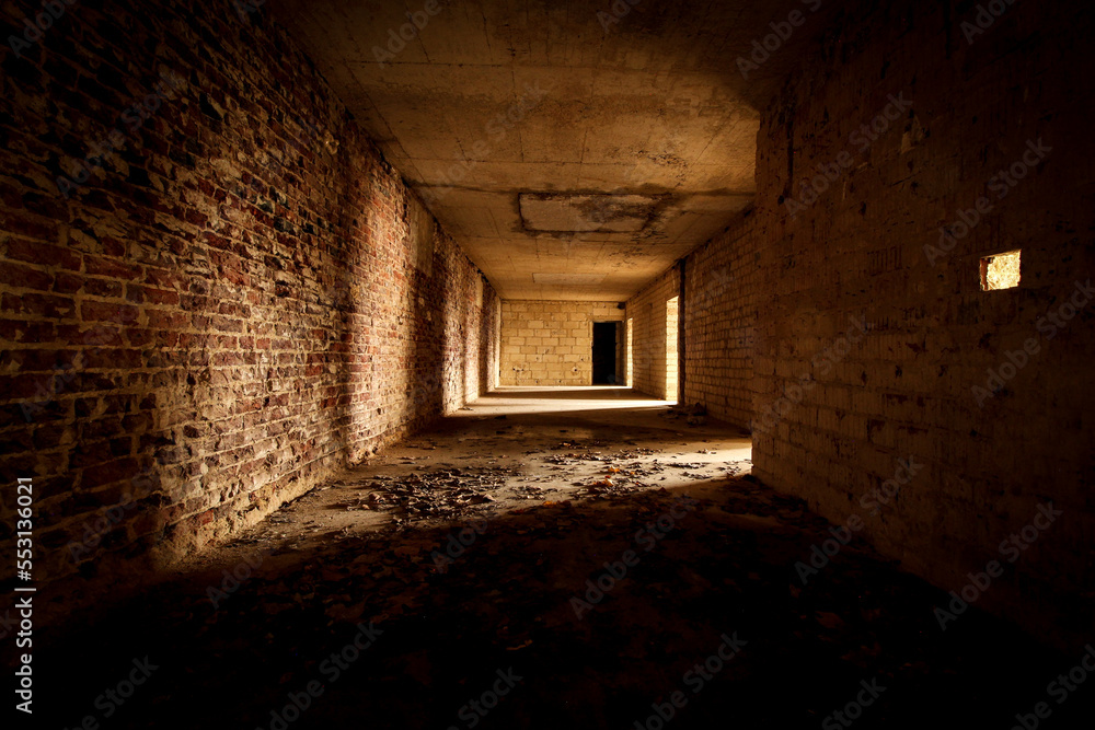 empty hallway with stone walls in a lost place