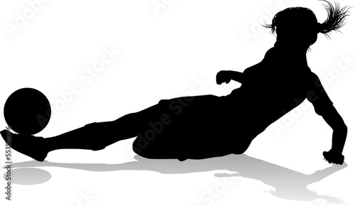 A female soccer football player woman in silhouettes