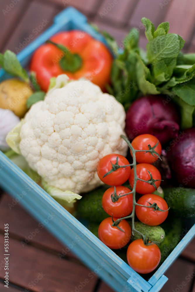 Fresh cherry tomatoes with organic vegetables in crate Fresh cherry tomatoes with organic vegetables in crate