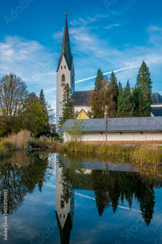 Germany, Bavaria, Oberstdorf, St. Johannes Baptist church reflecting in lake photo