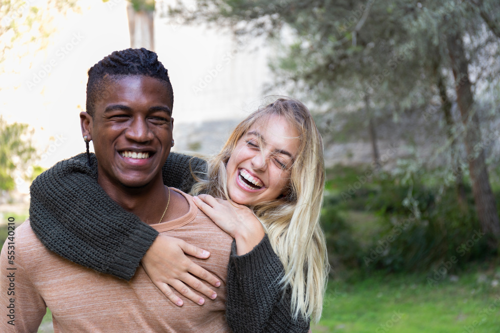 Cheerful woman having fun with boyfriend in park Cheerful woman having fun with boyfriend in park