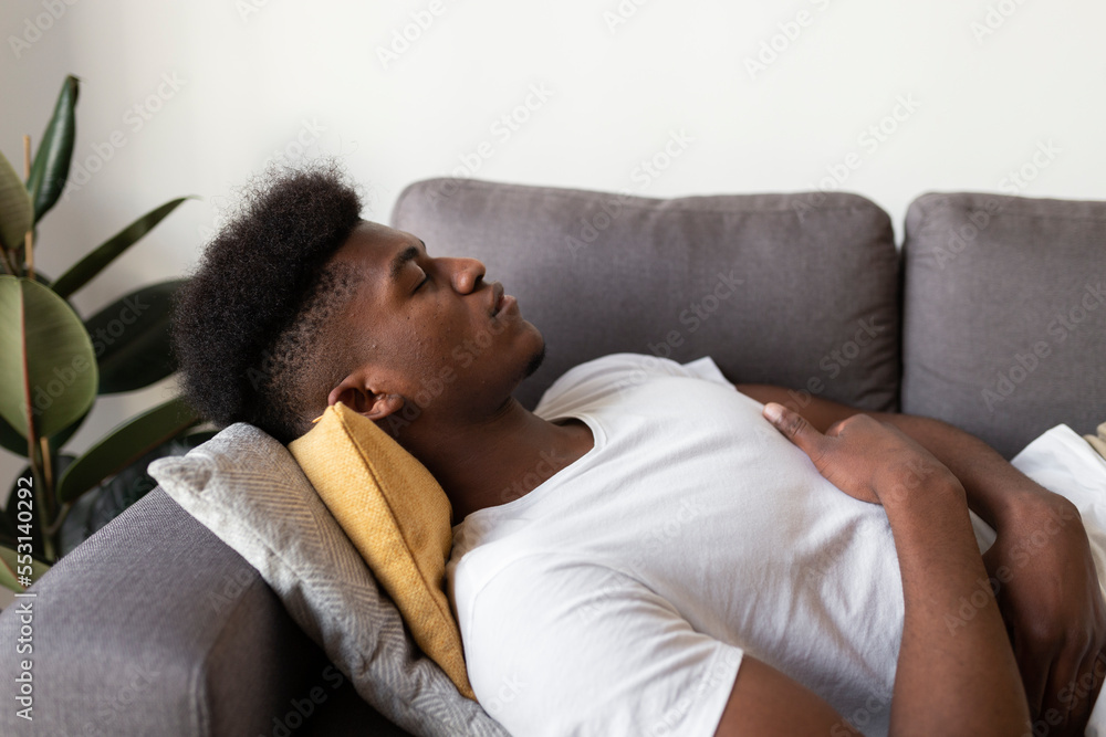 Young man sleeping on sofa at home Young man sleeping on sofa at home