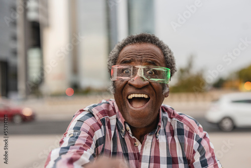 Excited man with mouth open wearing smart glasses photo
