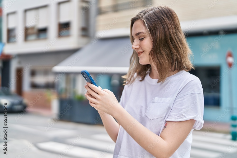 Young woman smiling confident using smartphone at street Young woman smiling confident using smartphone at street