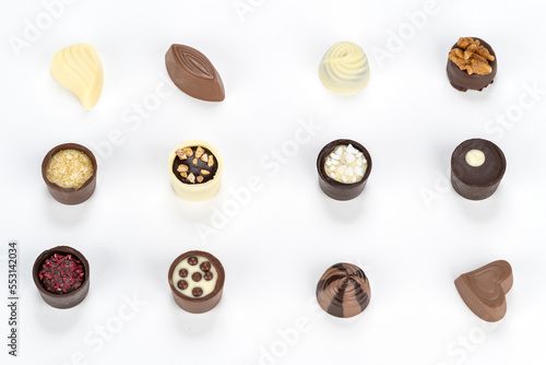 Chocolate temptation with a variety of delicious chocolate candies on a white background.