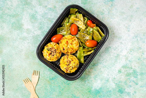 Studio shot of take out rice muffins with cherry tomato and green bean salad photo