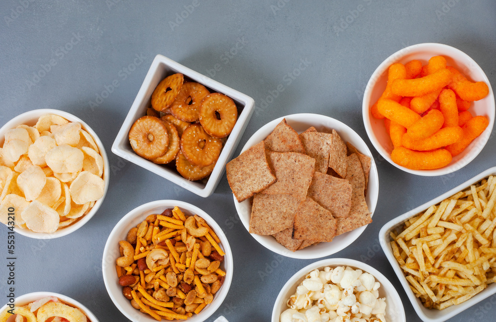 Party snacks, an assortment on gray with copy space Party snacks, an assortment on gray with copy space