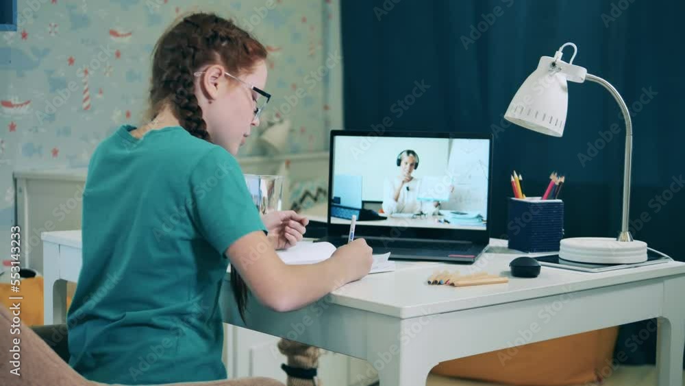 Little schoolgirl taking an online class. Remote education, distant studying, on-line education concept. Little schoolgirl taking an online class. Remote education, distant studying, on-line education concept.