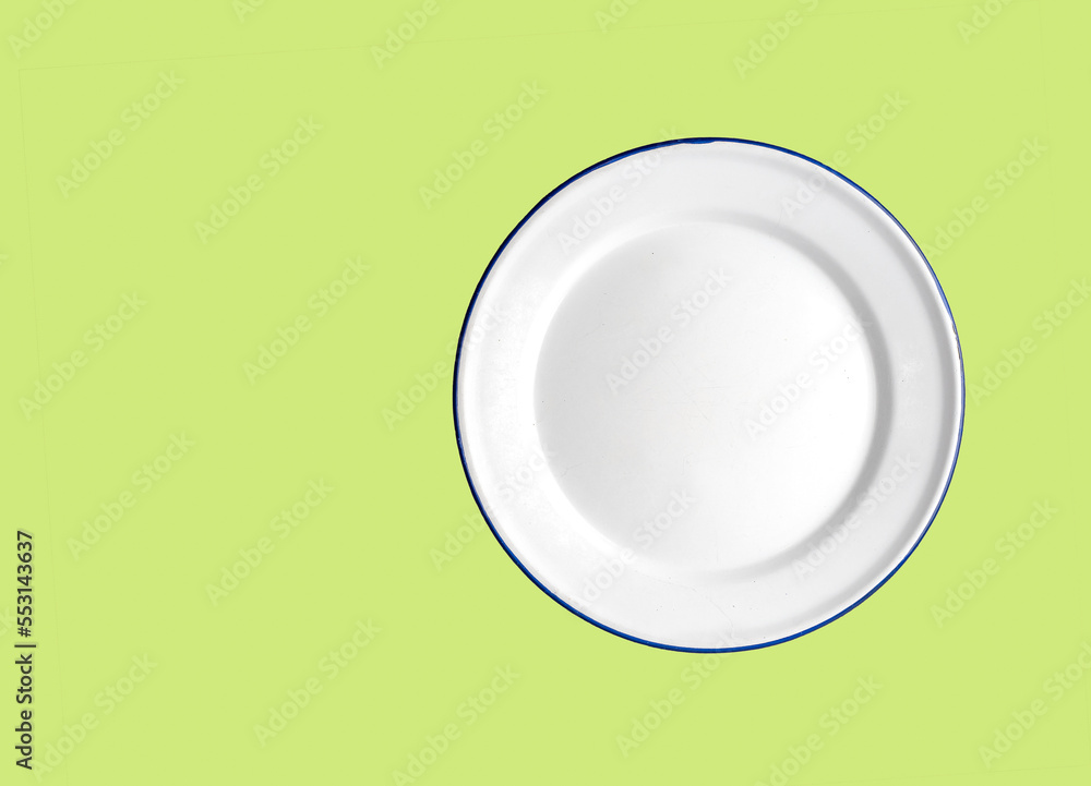 Oven safe enamelled white plate on a Lime green background Oven safe enamelled white plate on a Lime green background