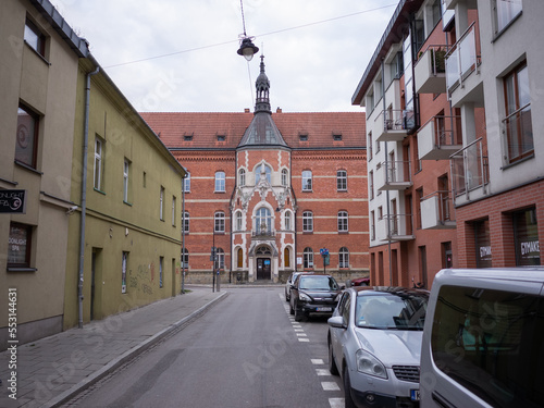 empty path and parked cars on the road side in krakow old city
