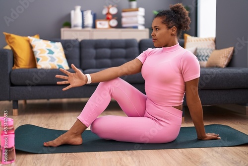 African american woman doing yoga exercise at home