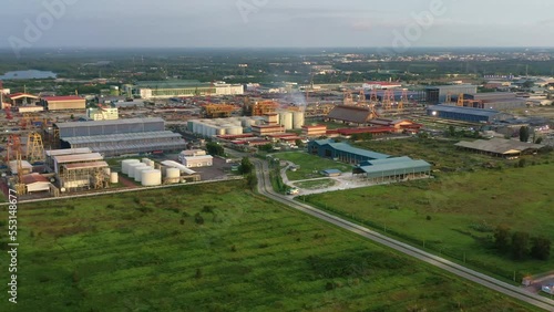 Aerial pan shot capturing massive area of lumut port industrial park, PGEO edible oil refinery food processing centre and sapura energy fabrication yard at Kampung Acheh, Sitiawan, Perak, Malaysia. photo