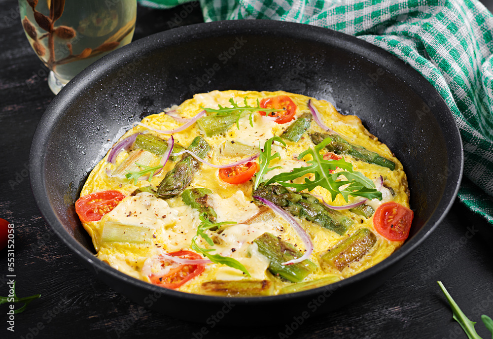 Healthy asparagus omelette. Eggs omelet with asparagus, tomatoes, and cheese. Healthy asparagus omelette. Eggs omelet with asparagus, tomatoes, and cheese.