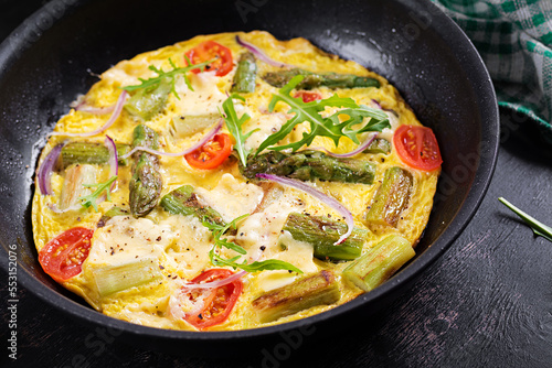 Healthy asparagus omelette. Eggs omelet with asparagus, tomatoes, and cheese.