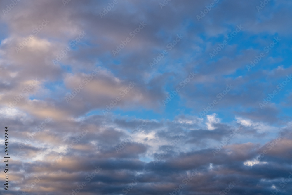 Beautiful sunset or sunrise sky, illuminating dark blue and pale pink clouds. Cloudy sky to overlay on your photos