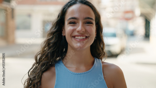 Young beautiful hispanic woman smiling confident standing at street Free Download Young beautiful hispanic woman smiling confident standing at street - GFXLoad