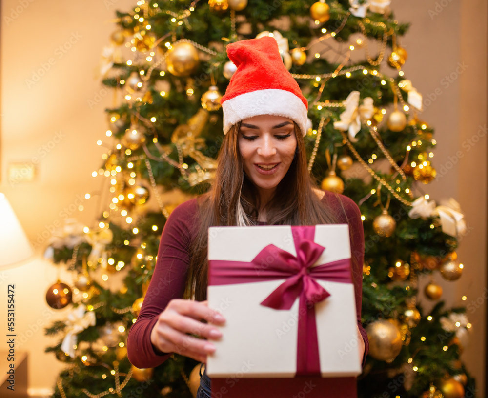 Woman opening a Christmas gift