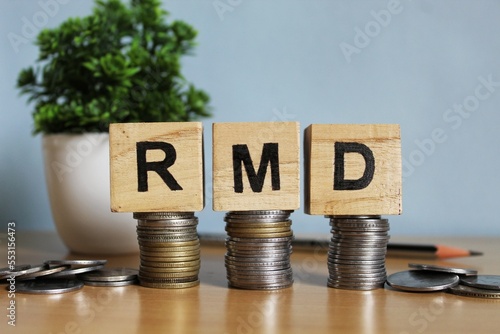 RMD concept, Required minimum distribution concept on wooden blocks.