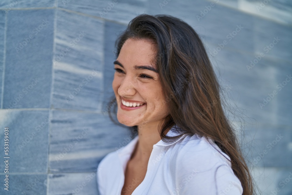 Young hispanic woman smiling confident looking to the side at street Young hispanic woman smiling confident looking to the side at street