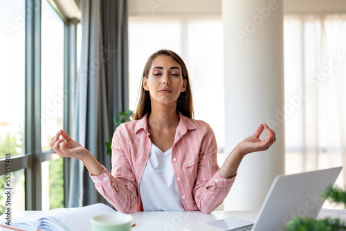 Quadro su tela Calm woman relaxing meditating with laptop, no stress free relief at work concep