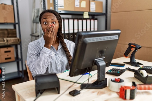 African woman working at small business ecommerce shocked covering mouth with hands for mistake. secret concept. © Krakenimages.com