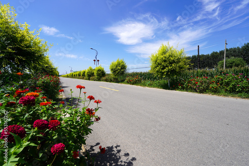 The asphalt road is under the blue sky