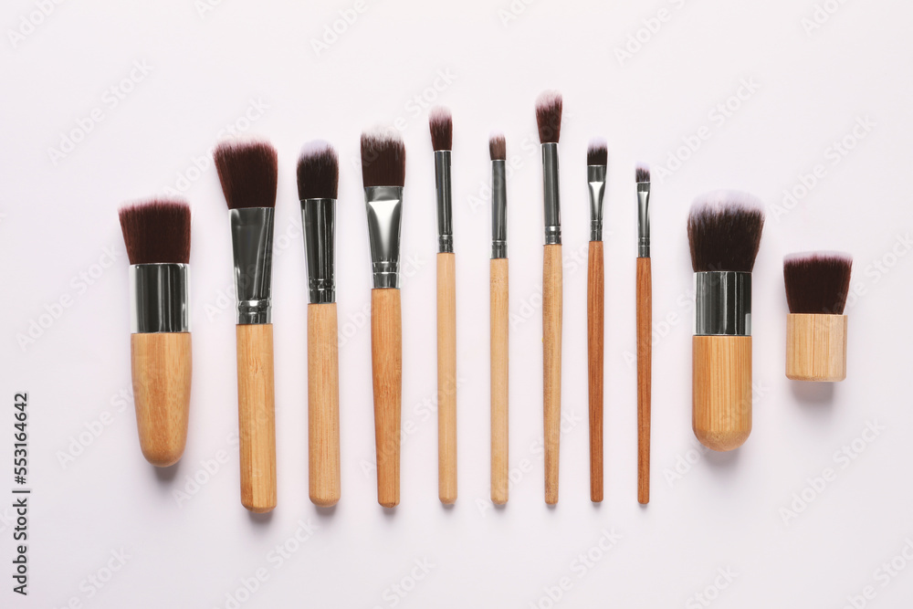 Different makeup brushes on white background, flat lay Different makeup brushes on white background, flat lay