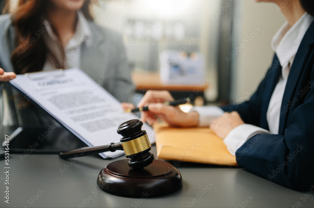 Male lawyer in the office with brass scale on wooden table. justice and law concept Male lawyer in the office with brass scale on wooden table. justice and law concept