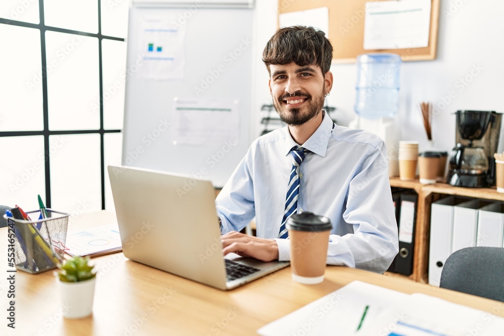Young hispanic businessman smiling happy working at the office. Young hispanic businessman smiling happy working at the office.