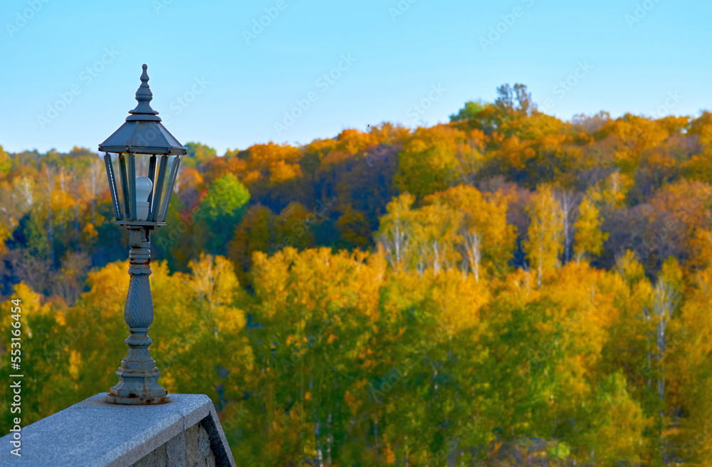 Old fashioned lantern over autumn calm landscape