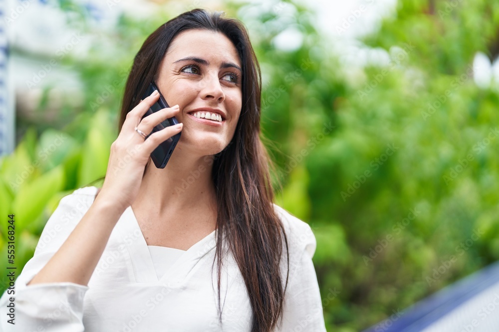 Young beautiful hispanic woman smiling confident talking on the smartphone at park Young beautiful hispanic woman smiling confident talking on the smartphone at park