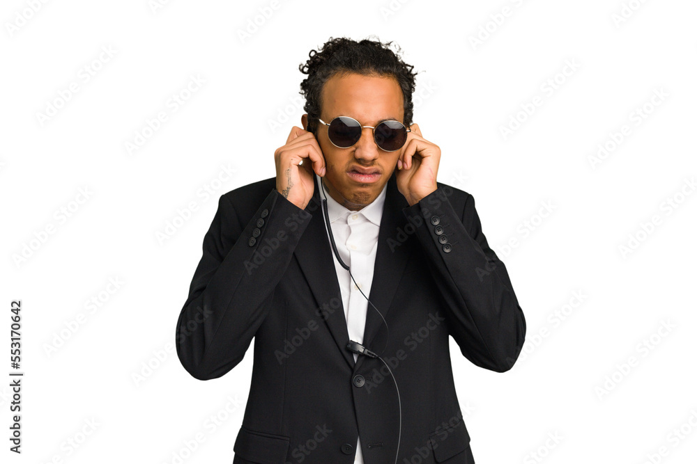 Young African American bodyguard man isolated covering ears with hands. Young African American bodyguard man isolated covering ears with hands.