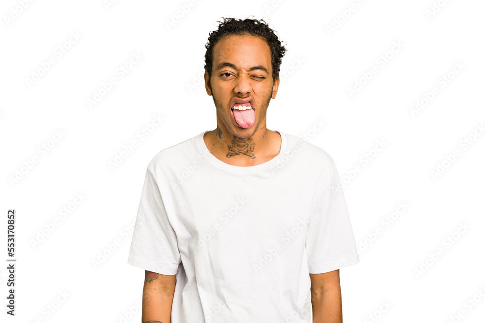 Fototapeta premium Young African American man isolated funny and friendly sticking out tongue.