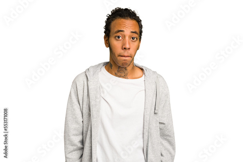 Young African American man isolated shrugs shoulders and open eyes confused.