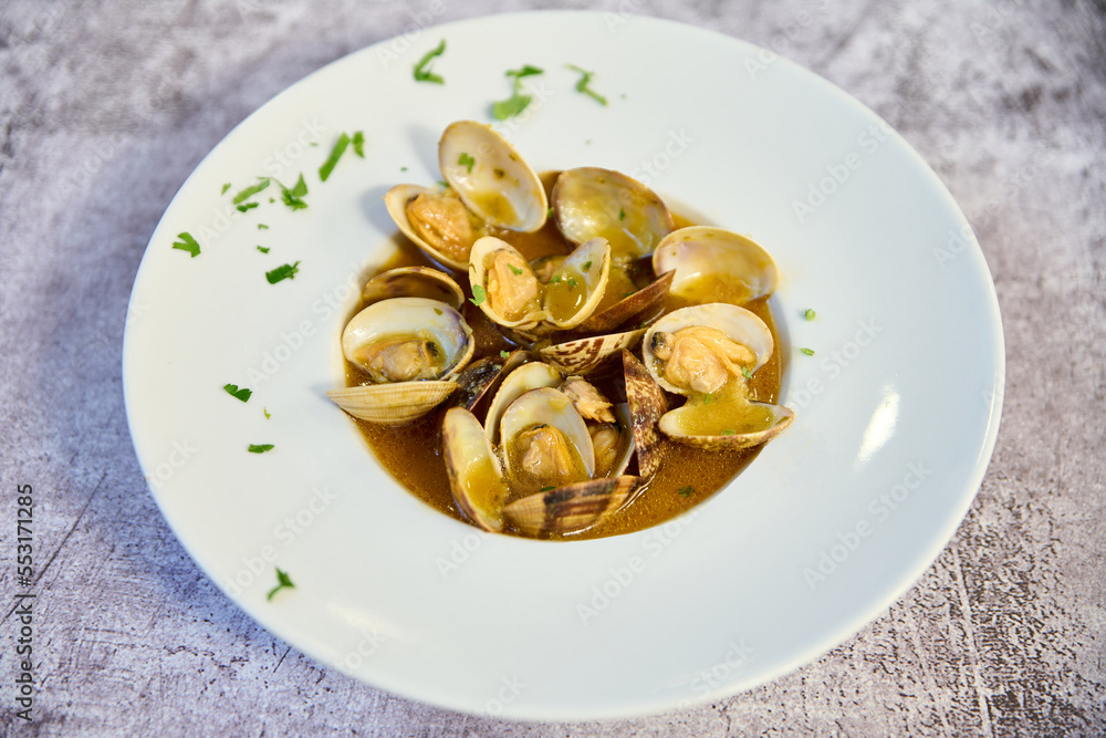 Clam stew plate on white marble table Clam stew plate on white marble table