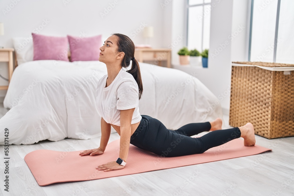 Young hispanic woman training yoga at bedroom Young hispanic woman training yoga at bedroom