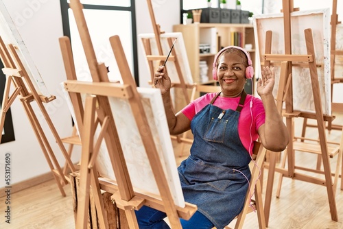 Senior african american woman listening to music drawing at art studio