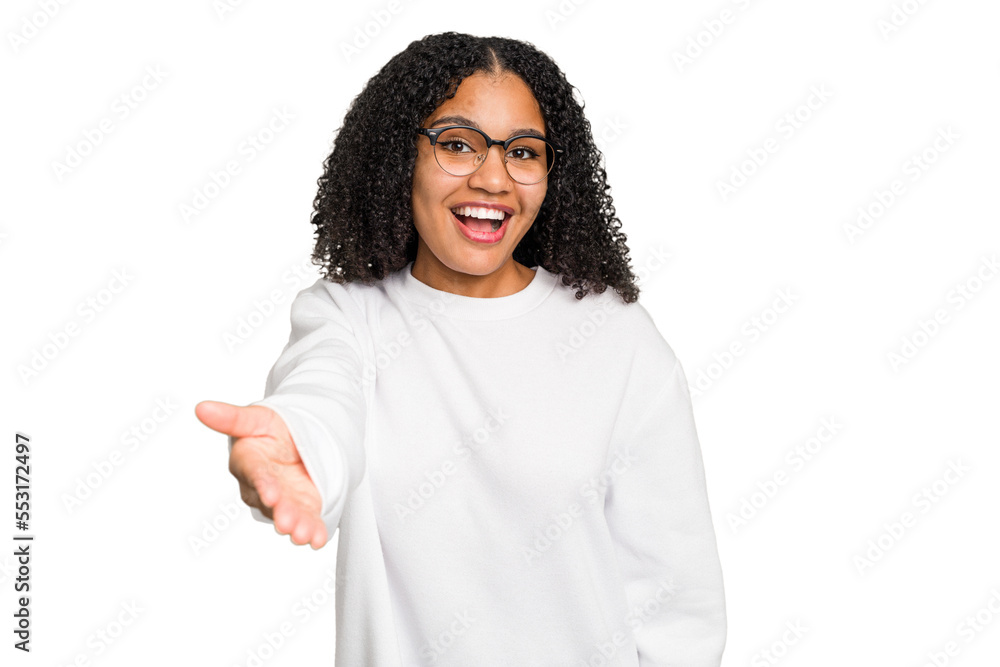 Young african american woman with curly hair cut out isolated stretching hand at camera in greeting gesture. Young african american woman with curly hair cut out isolated stretching hand at camera in greeting gesture.