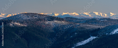 Travny hill in Moravskoslezske Beskydy mountains with Tatra mountains on the background during beautiful winter day photo