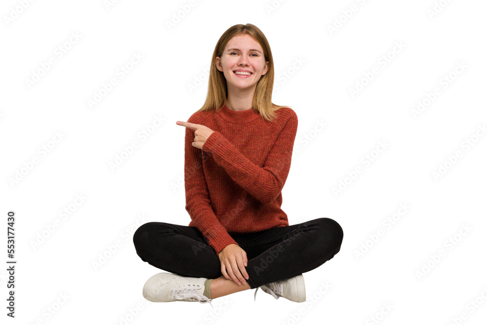 Young caucasian woman sitting on the floor cutout isolated Young caucasian woman sitting on the floor cutout isolated