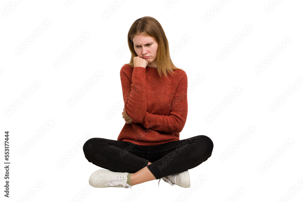 Young caucasian woman sitting on the floor cutout isolated Young caucasian woman sitting on the floor cutout isolated