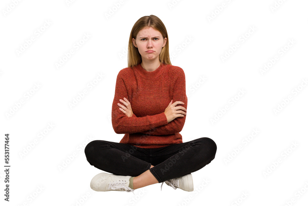 Young caucasian woman sitting on the floor cutout isolated Young caucasian woman sitting on the floor cutout isolated