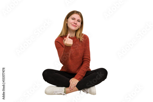 Young caucasian woman sitting on the floor cutout isolated