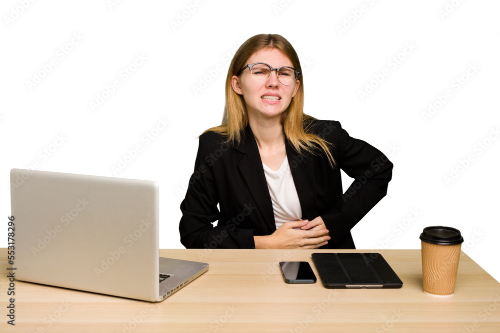 Young business caucasian woman working on her workplace cutout isolated having a liver pain, stomach ache. Young business caucasian woman working on her workplace cutout isolated having a liver pain, stomach ache.