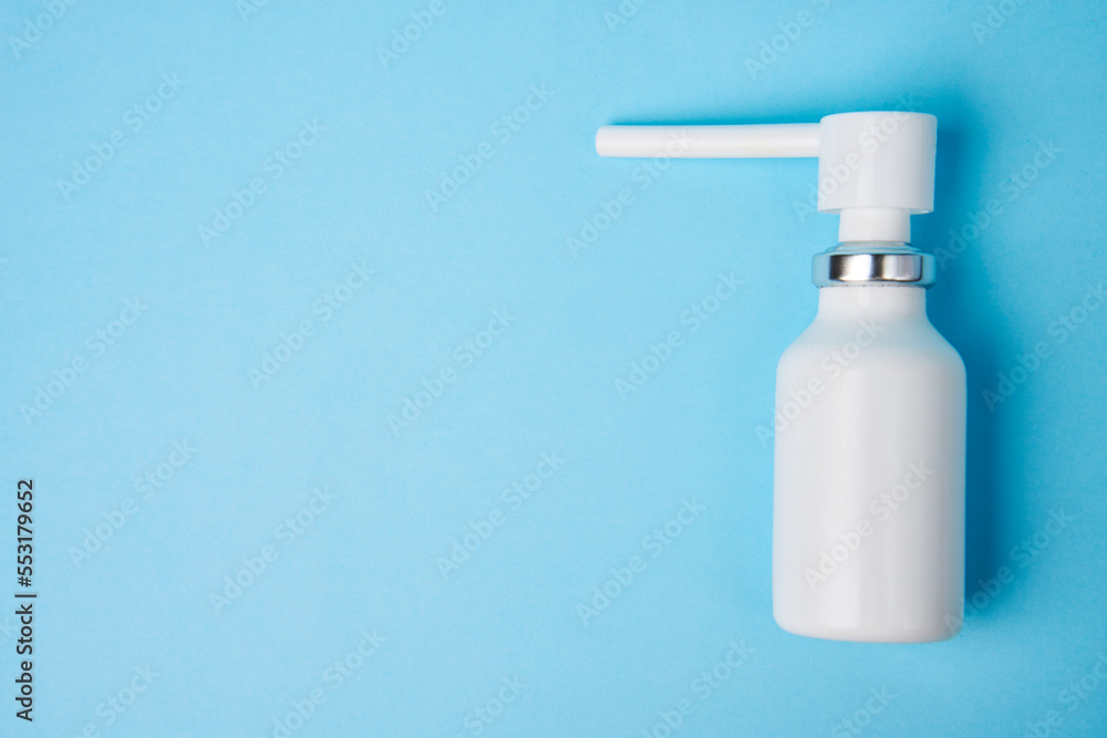 Nasal spray bottle on blue background with copy space Nasal spray bottle on blue background with copy space