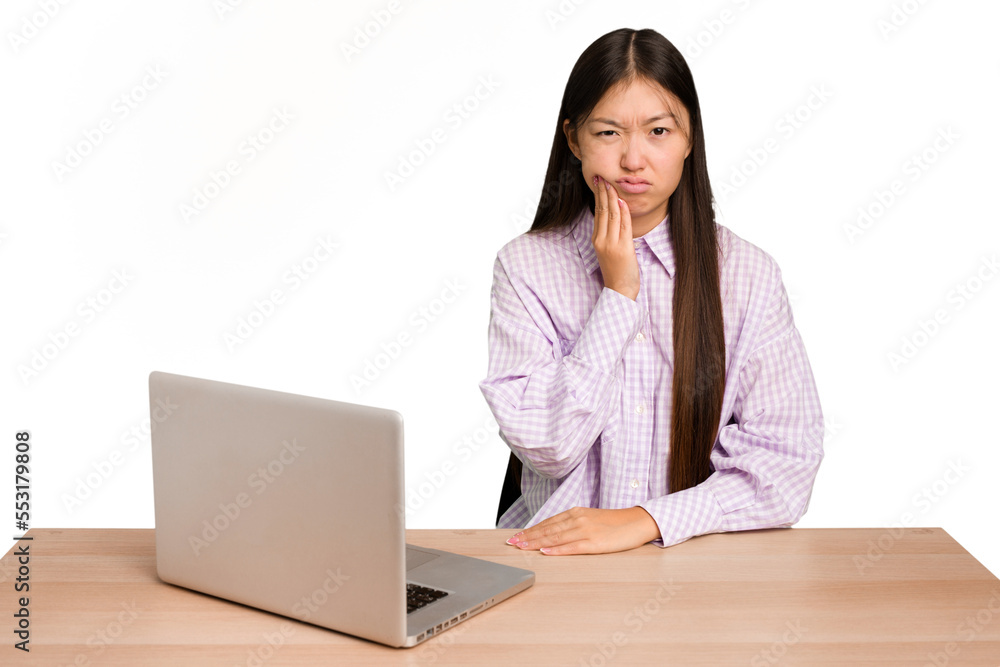 Young student asian woman in a workplace with a laptop isolated having a strong teeth pain, molar ache. Young student asian woman in a workplace with a laptop isolated having a strong teeth pain, molar ache.