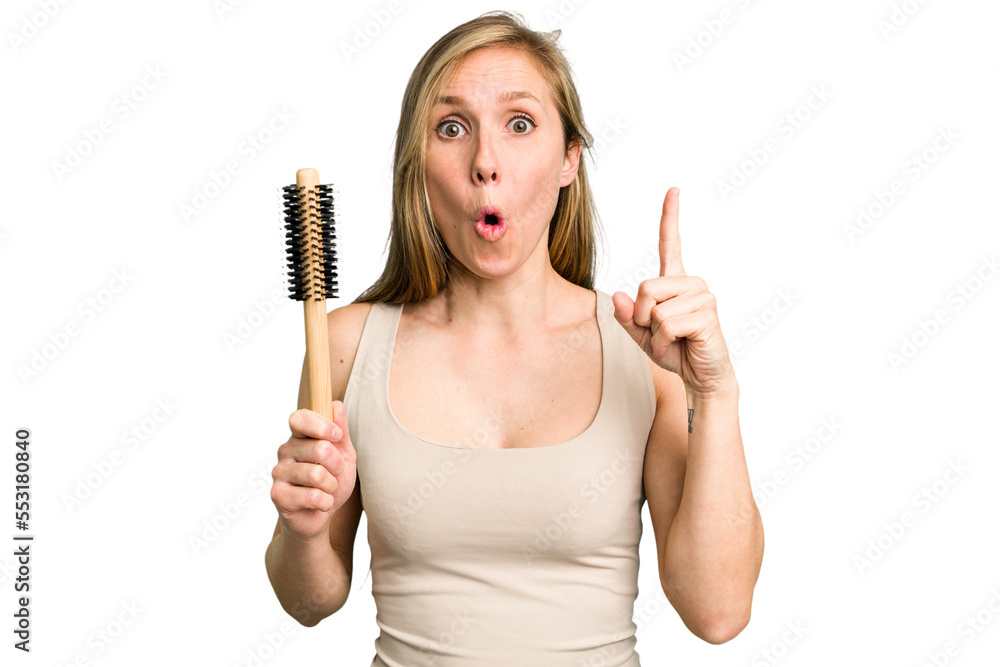 Young caucasian woman using an hair comb isolated having some great idea, concept of creativity.