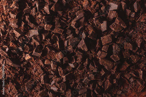 Flat lay view of dark chocolate chopped. Texture of cracked chocolate with copy space.