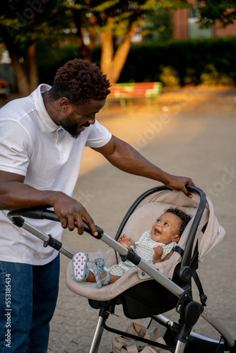 Young african american man with his kid in the park photo